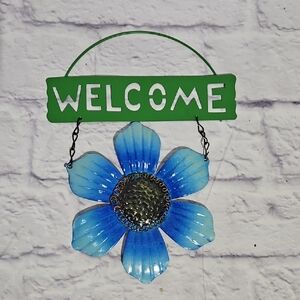 Blue and Green Welcome Sign with Flower